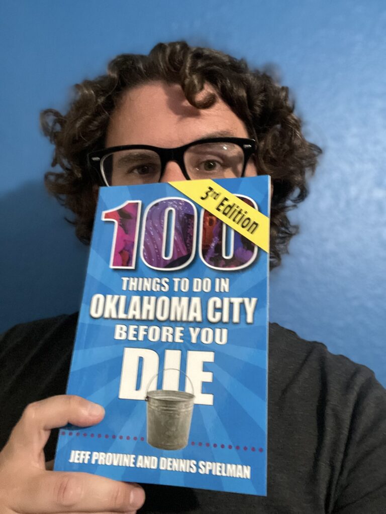 Selfie photo with a copy of 100 Things to Do in Oklahoma City Before You Die. 